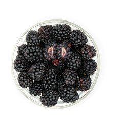 blackberries in a bowl from the home garden on a white background with one piece in a half