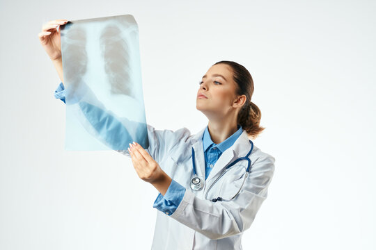 female doctor diagnosis x-ray examination hospital light background