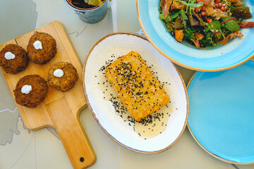 Overhead view at traditional Greek zucchini meatballs, feta cheese fried with crust, honey and...
