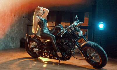 Obraz na płótnie Canvas Young woman sitting on motorcycle