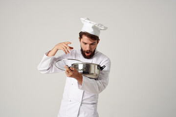 male chef with a saucepan in his hands cooking food kitchen restaurant