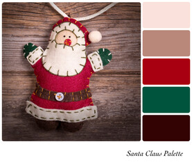 Retro style felt Santa Claus over old wood background. In a colour palette with complimentary...