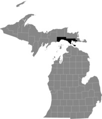 Black highlighted location map of the Mackinac County inside gray map of the Federal State of Michigan, USA