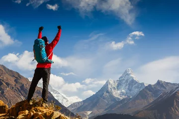 Keuken foto achterwand Mount Everest Young male hiker with backpack on top of a mountain during sunny summer day