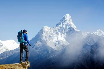 Printed kitchen splashbacks Mount Everest Young male hiker with backpack relaxing on top of a mountain during sunny summer day
