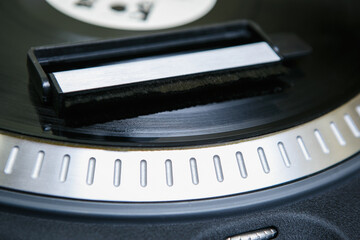 Antistatic brush on vinyl record disc. Professional analog audio equipment in close up