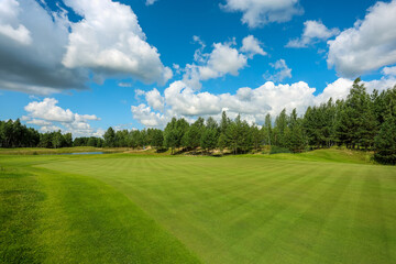 Fototapeta na wymiar Panorama view of a Golf Course with fairway field. Golf course with a rich green turf beautiful scenery. High quality photo