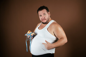 Funny fat man on a diet eats pizza.