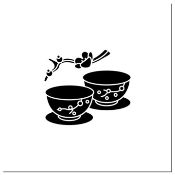 Japanese tea cups glyph icon. Ceremony two teacups with sakura pictures. Unique handmade ware. Tea ritual concept.Filled flat sign. Isolated silhouette vector illustration