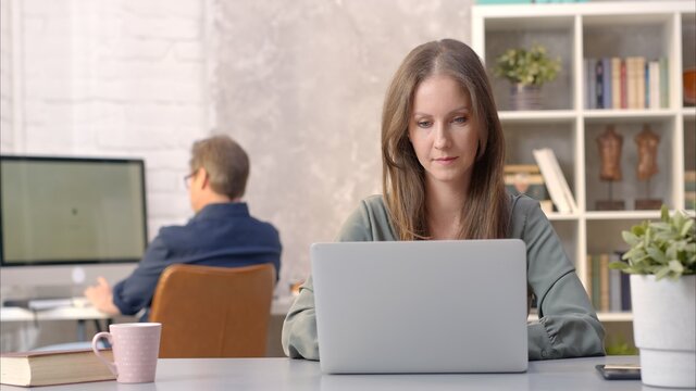 Business people working in office with laptop computer. Woman working from home at desk.