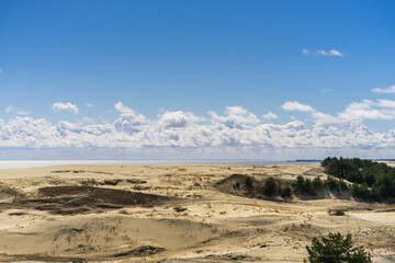 Fototapeta na wymiar Coast of the Baltic Sea. Sand dunes with clouds. Typical Baltic beach landscape.