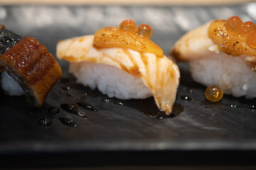Sushi salmon topping salmon roe and spicy cream sauce.