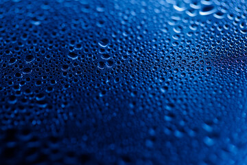 Drops on glass. Texture for designer background. Drops of water flow down the surface of the clear...