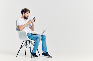 man in white t-shirt with laptop in headphones Lifestyle