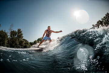 beautiful view of splashing wave and man riding it on foilboard