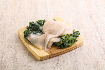 Raw squid over wooden board