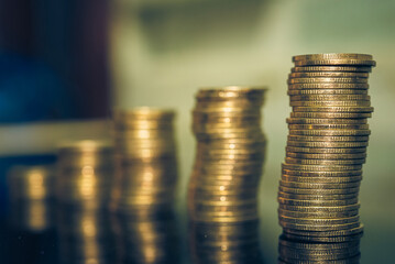 Gold coins stacks is representing riches and wealth management. Coin stack growing and find out the way to get a return on investment. Finance and money exchange investment as concept.	