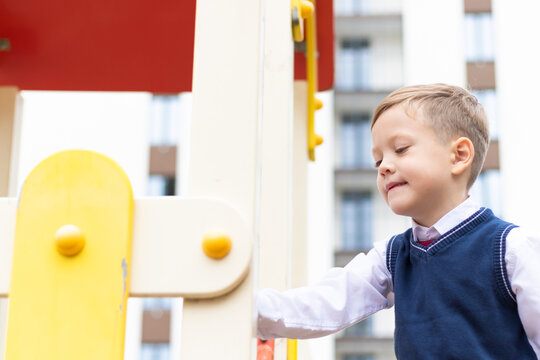 Cute Boy First Grader At School On The Playground On A Sunny Autumn Day. Celebration On September 1st. Knowledge Day. Selective Focus