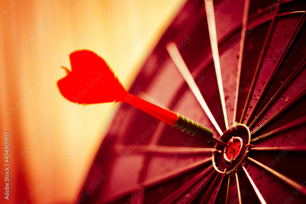 Aufkleber close up shot of the dart arrow hit on bulleyes of dartboard to represent that the business reached 