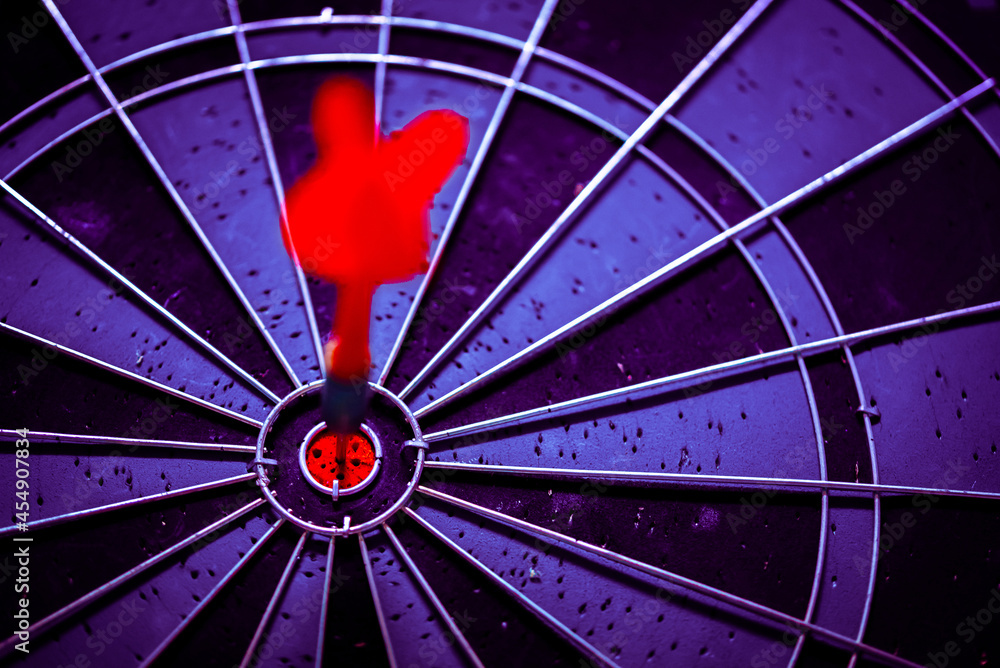 Aufkleber close up shot of the dart arrow hit on bulleyes of dartboard to represent that the business reached 