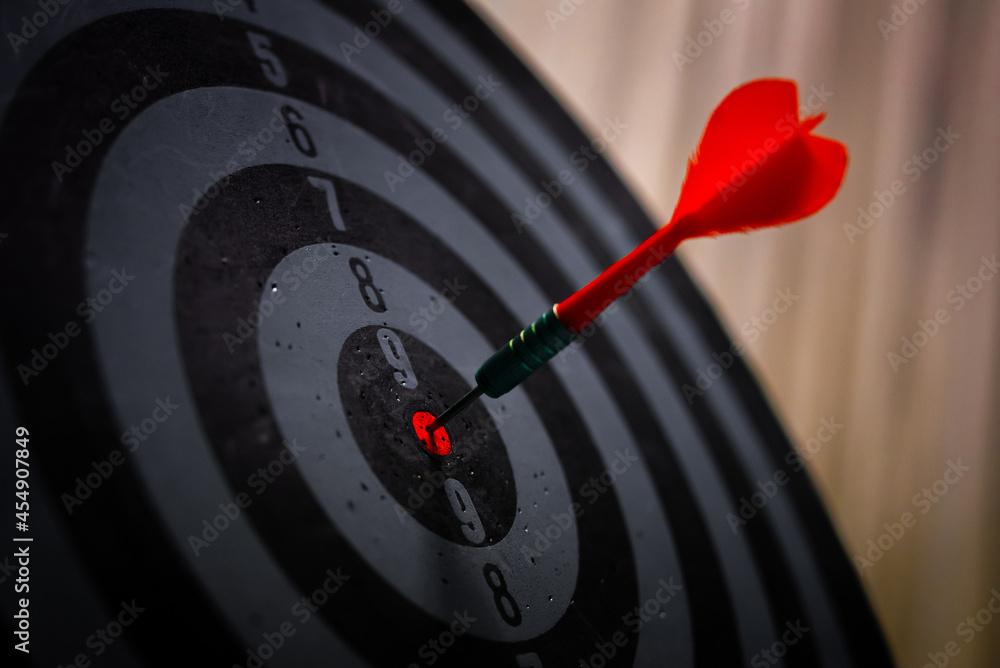 Aufkleber close up shot of the dart arrow hit on bulleyes of dartboard to represent that the business reached 