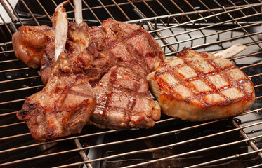 Large Juicy Beef Rib Eye Steak on a hot grill