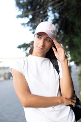 Portrait of a girl in a cap and white tshirt