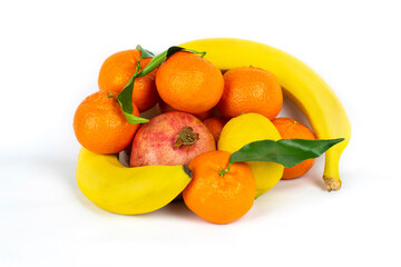 Delicious appetizing fruits on a white background - bananas, pomegranates, tangerines and lemons, a healthy snack during the day