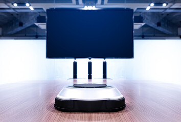 Wireless microphone portable on middle meeting table with blank screen television in Video conference meeting room