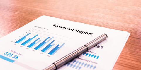 Financial Report document with pen on table