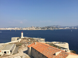 Fototapeta na wymiar Panoramic view of Marseille and the Massif de Saint-Cyr (right) seen from the tower of Château d'If, a fortress and former prison located on the Île d'If, the smallest island in the Frioul archipelago