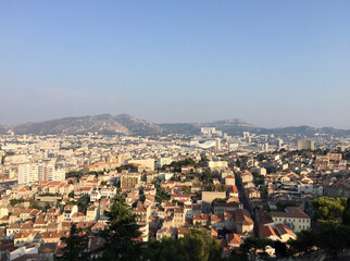 Fototapeta premium Panoramic view of Marseille's southern neighborhoods with the the Massif de Saint-Cyr in the background, seen from the Notre-Dame de la Garde basilica in Marseille, France.