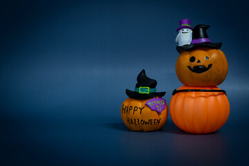 Jack o lantern pumpkin on a dark blue background. Halloween concept backdrop