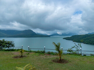 Aerial view of greenery, lake and clouds during the monsoon season at Mulshi near Pune India....