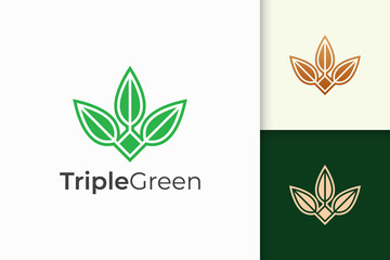 Triple leaf or flower logo in feminine and luxury style for health and beauty