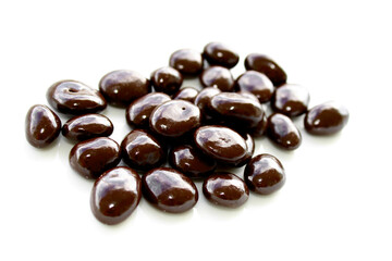 Chocolate covered nuts on white background, sweets with chocolate 