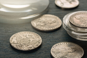 Numismatics. Old collectible coins made of silver on a wooden table. Numismatics. Old collectible...