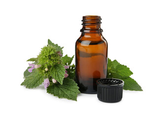 Glass bottle of nettle oil with leaves isolated on white