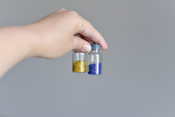 Multicolored beads close-up in bulk and packed in a bag or jar, for the work of needlewomen