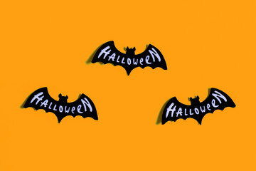Naklejka premium Ghosts and bats on a yellow and blue background. Halloween party