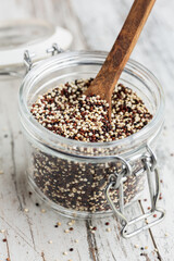 mixed quinoa raw seeds in a glass jar