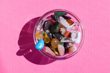 Collection Of Semi-Precious Gemstones on pink textured background