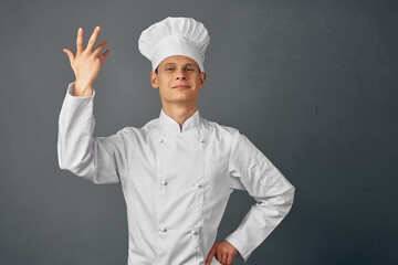 Naklejka premium a man in a chef's uniform gestures with his hands emotions gourmet restaurant