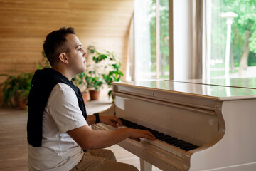 A student of the institute is sitting at the piano studying sheet music. Online distance learning...
