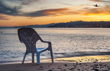 Sunset on sandy beach of Eilat - famous tourist resort in Israel