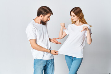 man and woman in white t-shirts socializing posing fashion design