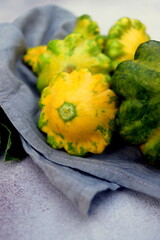 fresh squash vegetable of different shades close-up on a wooden board selective focus. 