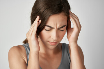 woman holding her head health problems discontent migraine