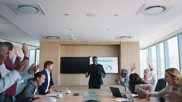 crazy business people celebrating in boardroom successful sales team corporate victory colleagues applause in office meeting enjoying winning success 4k