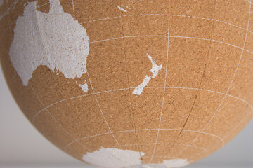 World Cork Ball showing New Zealand, with the island of New Caledonia, next to Australia and the island of Tasmania, in the Pacific Ocean in white color, background - Planning destinations © roferfrann